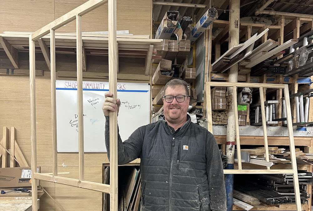 John holding some wood framing.