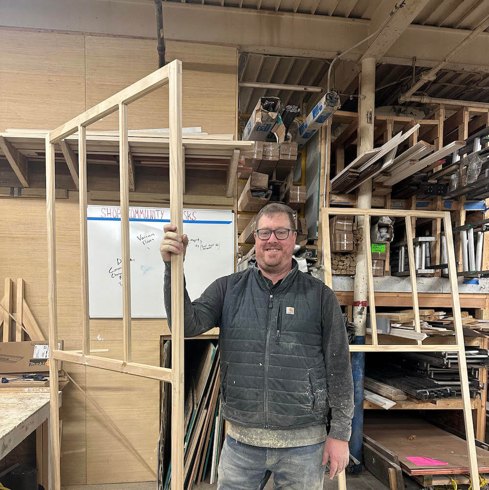 John holding some wood framing.