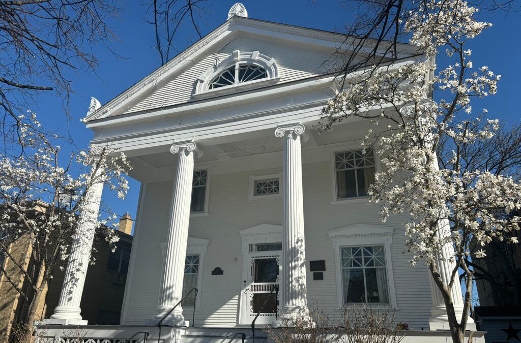 Front porch of a house with large pillars.